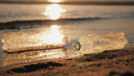 Two-Plastic-Bottles-Float-In-The-Water-Near-The-Shore-Plastic-Pollution-Concept