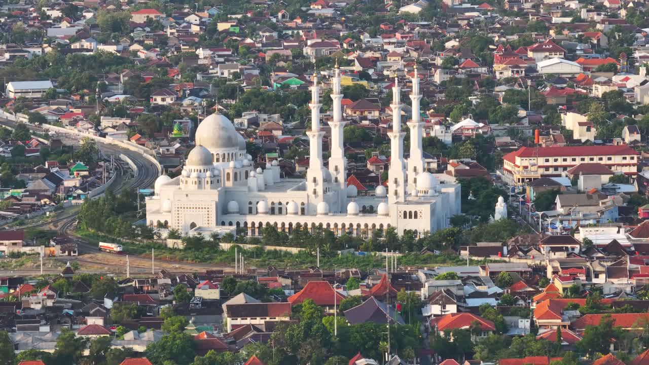 Aerial View of a Grand White Mosque in a Densely Populated City