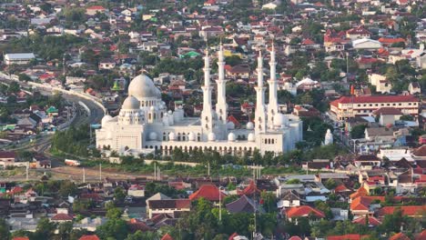 aerial view of a grand white mosque in a densely populated city