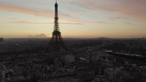 Fly-above-town-development-around-Eiffel-Tower.-Silhouette-against-colourful-twilight-sky.-Paris,-France