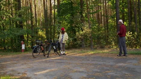 couple taking a break on a bike trip through the forest