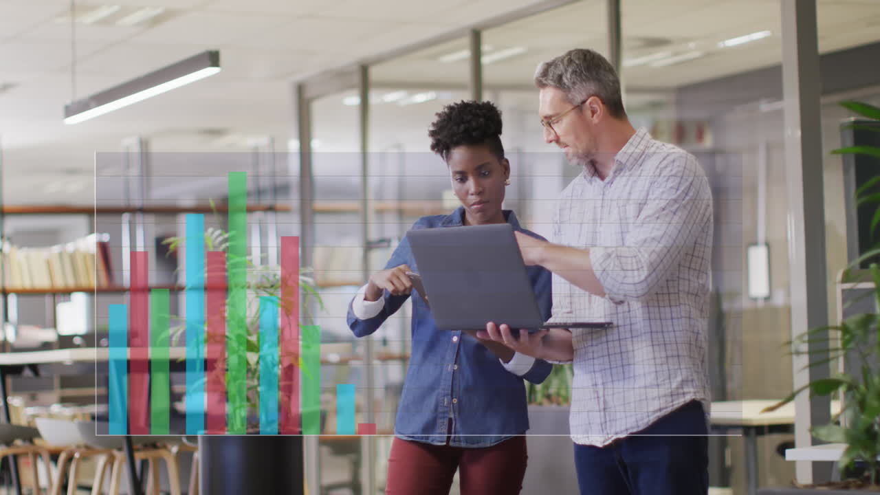 Animation of statistical data processing over diverse man and woman discussing over laptop at office