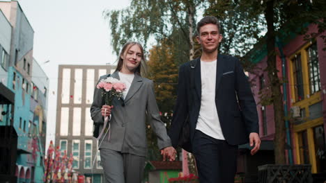 teenage boy and girl holding hands