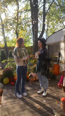 two friends enjoying autumn afternoon on a patio