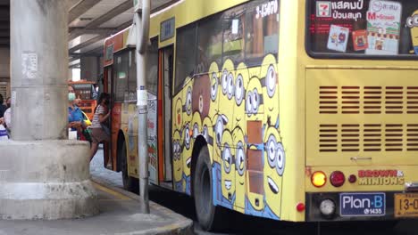 people entering a bus with cartoon characters