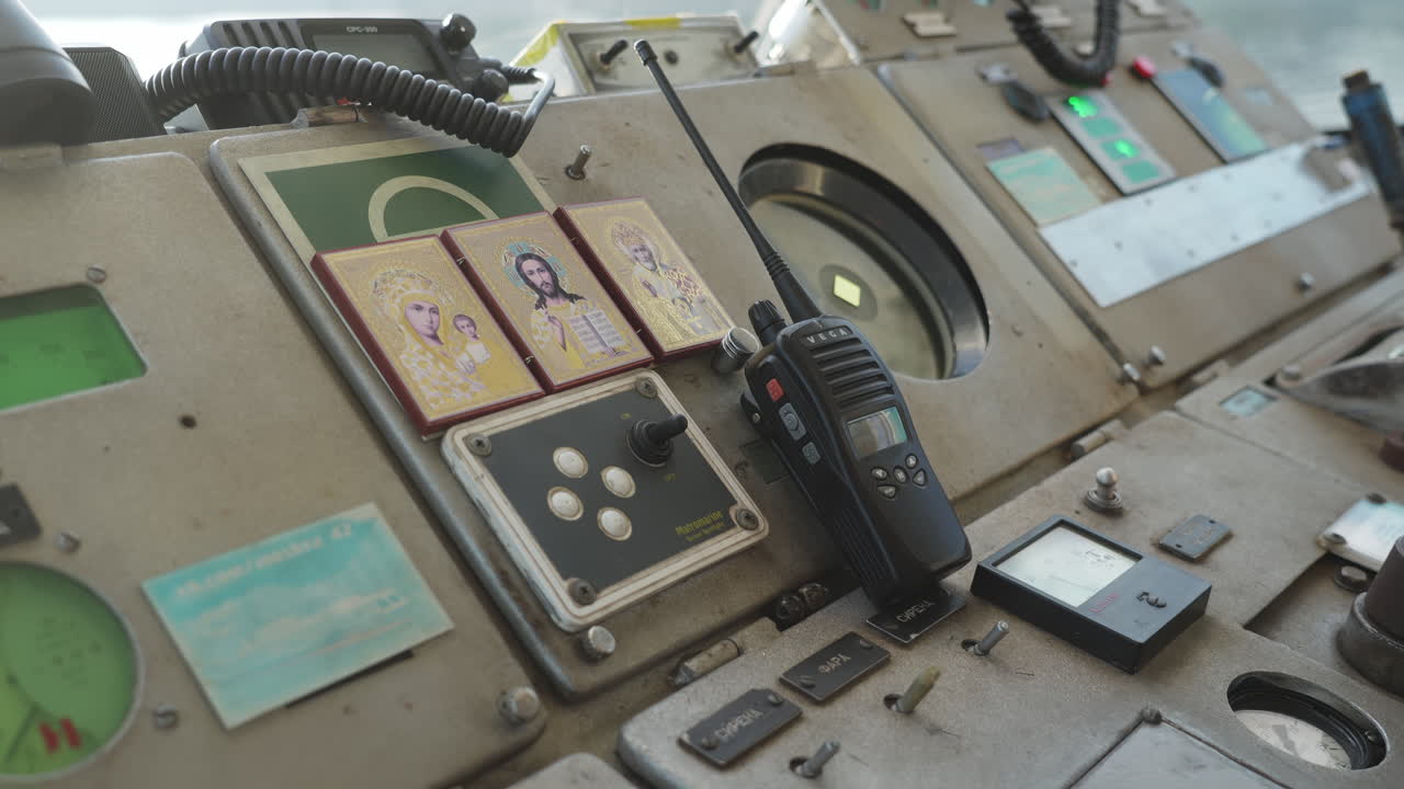 Man in ship cabin using walkie talkie