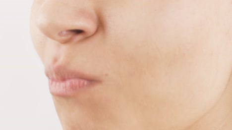 close-up of woman eating tangerine.