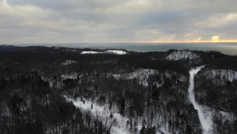 Sun-setting-through-the-clouds-over-PJ-Hoffmaster-Park-in-Muskegon,-MI