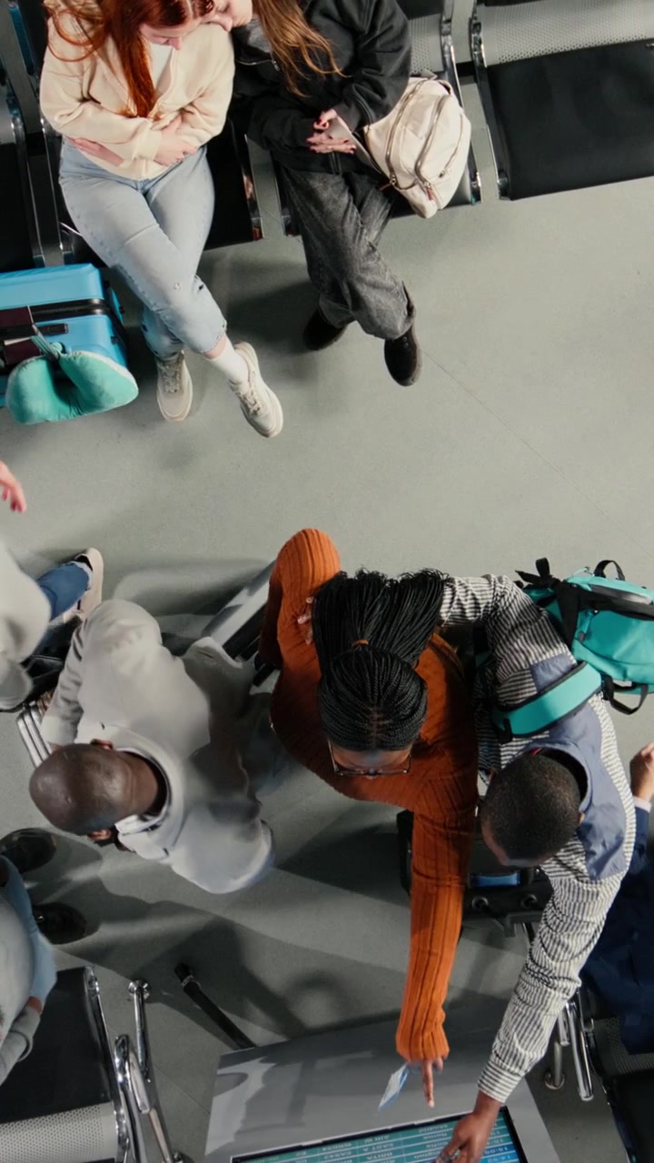 Overhead View of Diverse Travelers Waiting and Departing in Airport Lounge