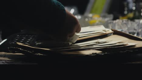 person checking old mail letters in nostalgic moody study scene
