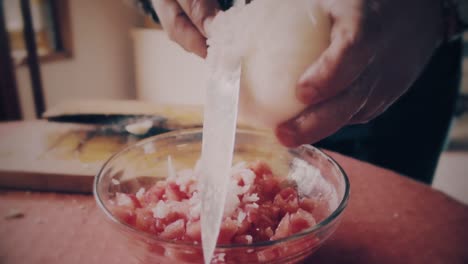 hands-close-up-cutting-a-onion-in-small-pieces-to-make-salad