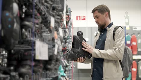 man shopping for rollerskates in a store