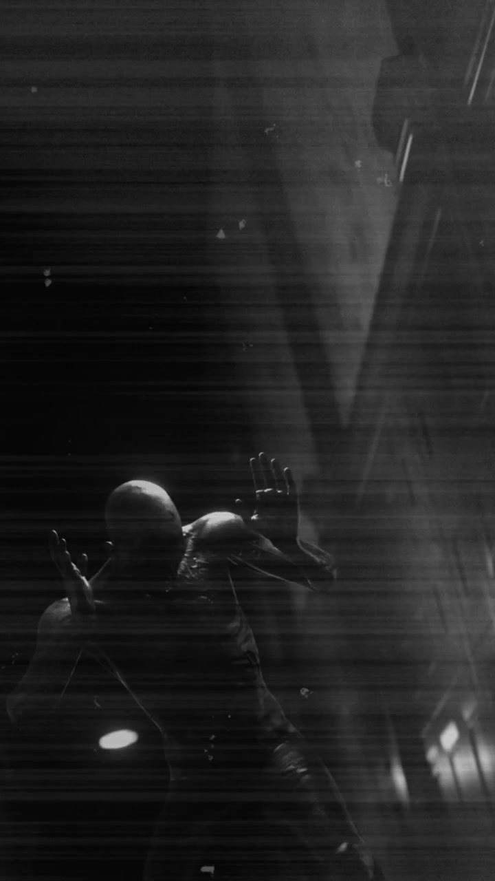 Animation of black and white scratched film of scary figure in dark corridor holding head in pain