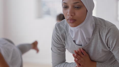 beautiful muslim woman practicing yoga prayer pose in fitness studio enjoying healthy balanced lifestyle wearing headscarf