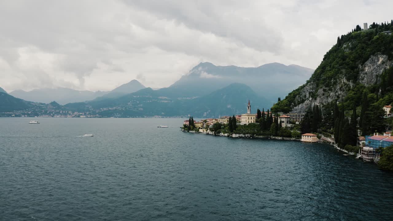 Drone shot approaching Italy's town of Varenna on Lake Como