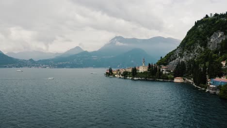 drone shot approaching italy's town of varenna on lake como