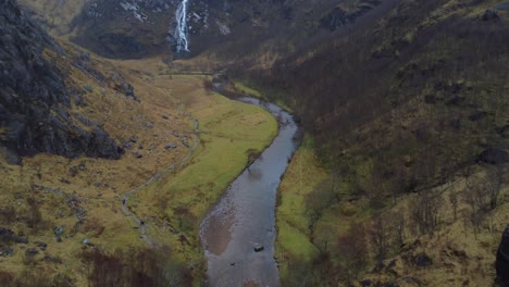 cinematic drone video in 4k of incredible scottish landscape and big waterfall in autumn - steall falls in glen nevis valley, scotland, uk