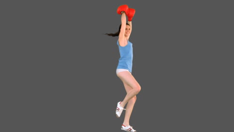 young model in sportswear and boxing gloves dancing