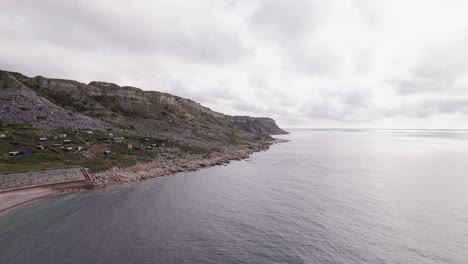 Drone-shot-flying-left-showing-the-cliffs-of-the-Isle-of-Portland-on-a-sunny-day,-Weymouth,-Dorset,-UK