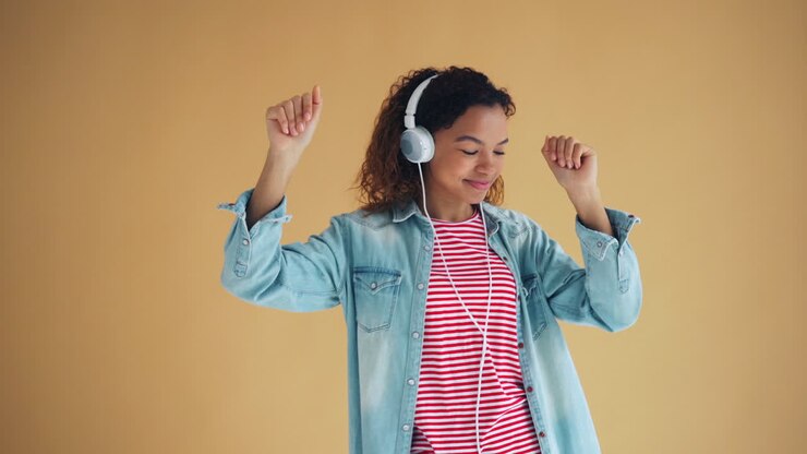 Teenage girl listening to music and dancing