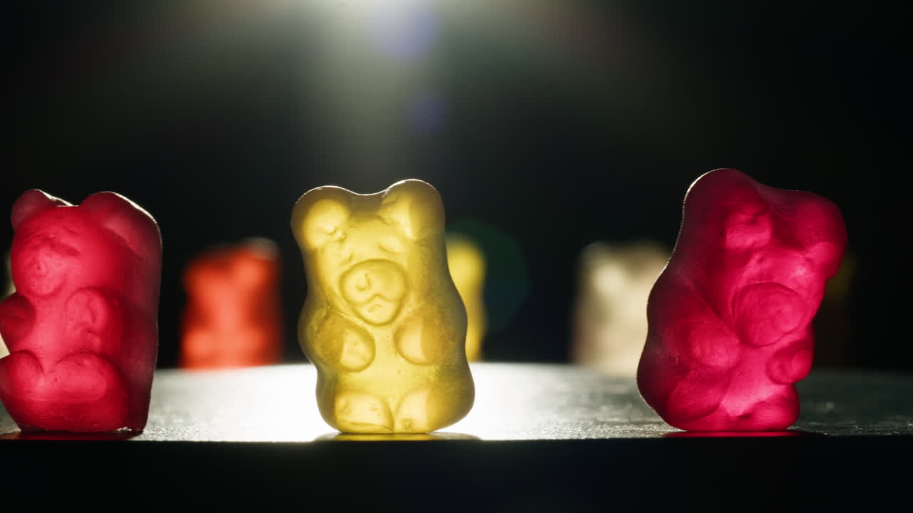 Colorful Gummy Bears under Spotlight