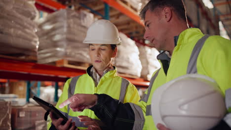 warehouse workers using tablet for inventory management