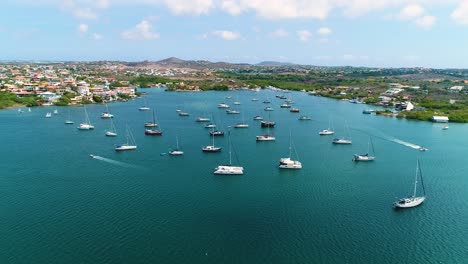 high angle aerial static of catamaran and sailboats anchored in spanish waters curacao