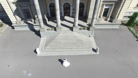 wedding day. wedding session. aerial shot of a happy wedding couple hugs each other before old building