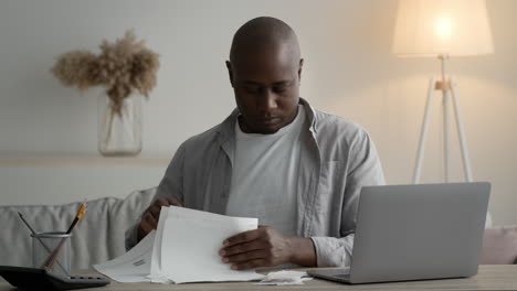 man paying bills at home