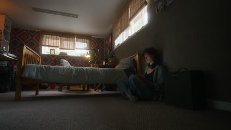 woman working on a laptop in a bedroom