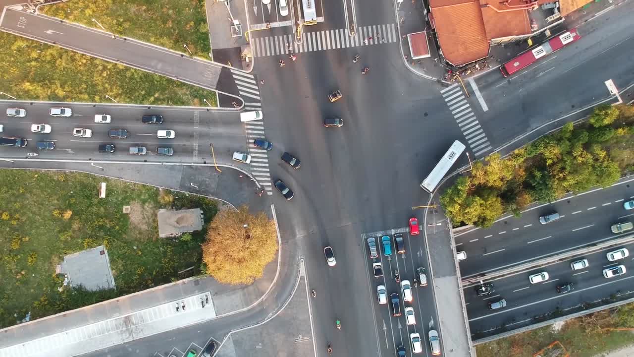 Big urban crossroad, vehicle moving, top down drone