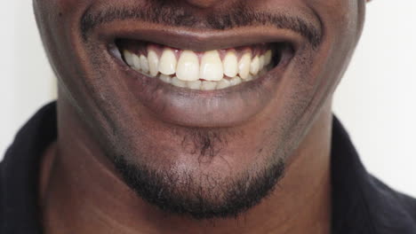 close up african american man mouth smiling cheerful happy showing healthy white teeth dental health concept