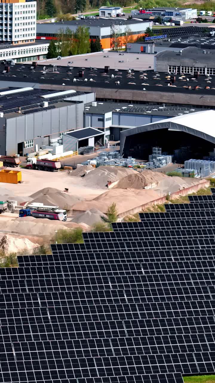 Aerial view of a large solar farm next to an industrial zone