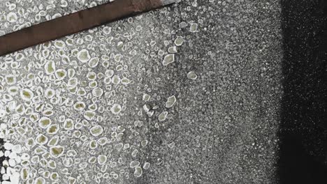 waves round ice water of lake bay sea pier. the texture of nature. aerial view