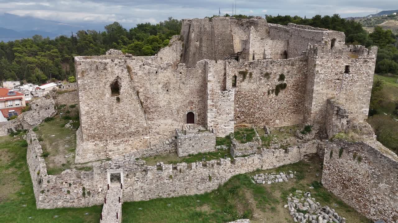 Patras Castle,Aerial view circle pan right around the highest point,main building of the Castle on a cloudy day.Background is the city view,sea and the mountains at the other coast