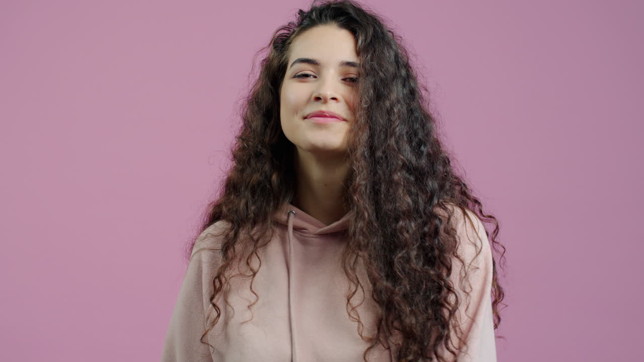 Woman with Curly Hair in a Hoodie