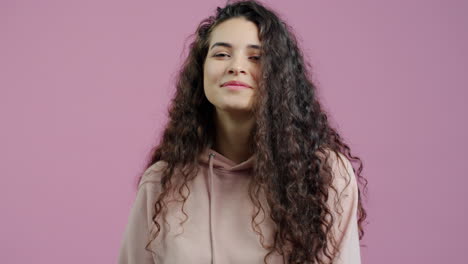 woman with curly hair in a hoodie
