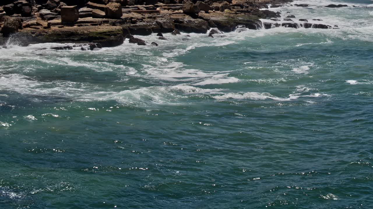 Coastline view of water and rocks in Portugal during daytime