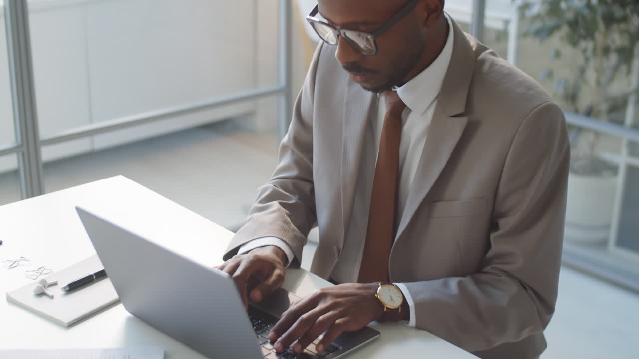 African American Businessman Using Laptop in Office