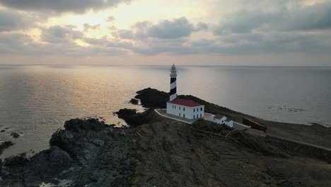 working favaritx lighthouse guides the way along the spanish coastline of menorca