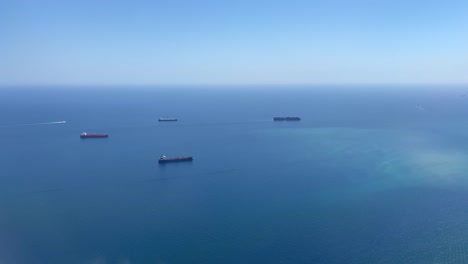 aerial view of cargo ships on mediterranean coast by barcelona harbor