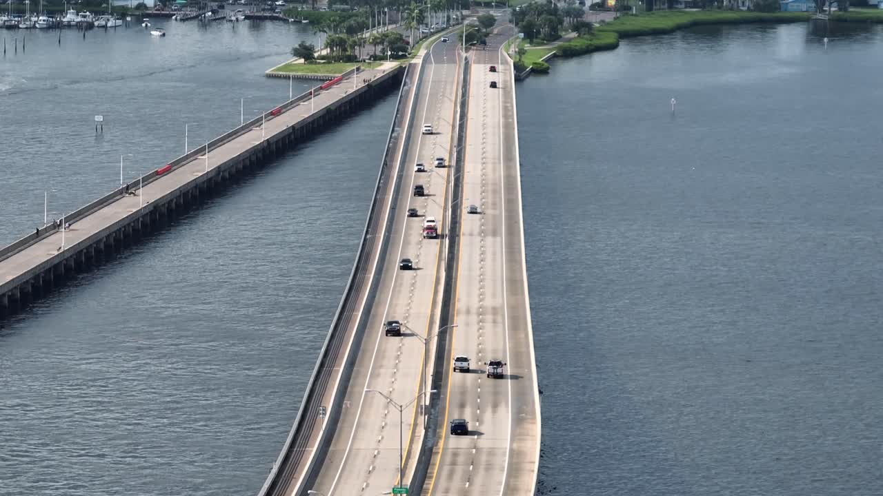 Cars on Bridge crossing manatee River and arriving Bradenton town, Florida. Sunset evening in summer. Palmetto fishing pier In USA