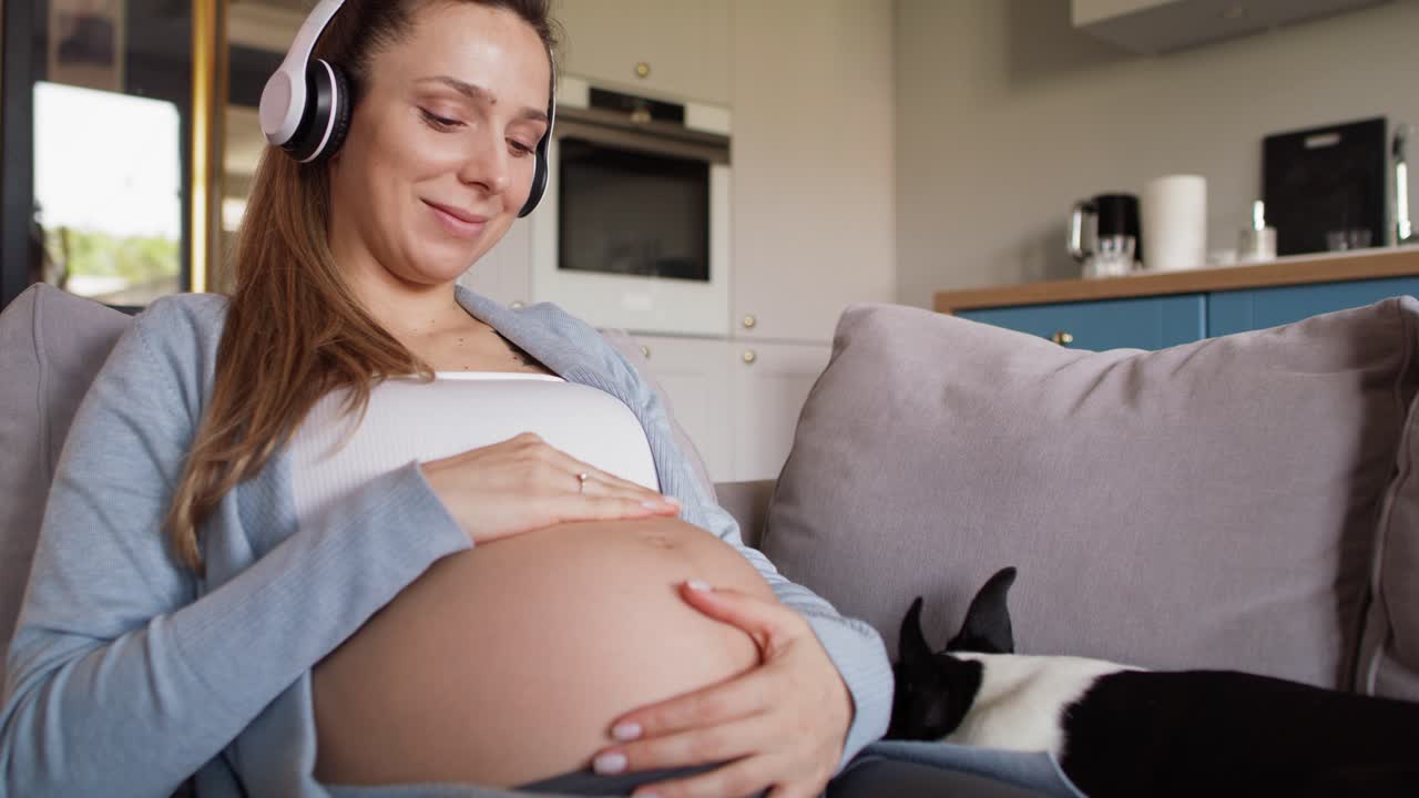 Femme enceinte écoutant avec un casque