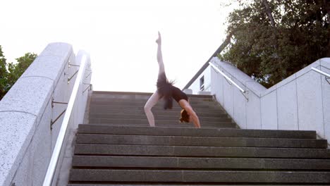 female ballet dancer stretching on the steps 4k