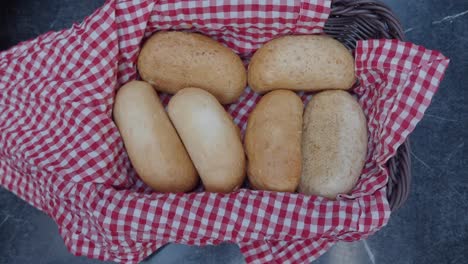 preparing bread in a basket with checkered cloth