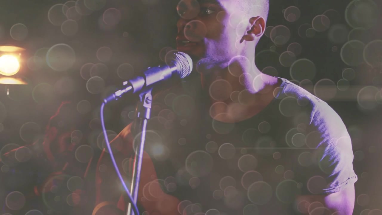 Photographer raising DSLR and aiming, capturing music band while animated bokeh over singer, drums