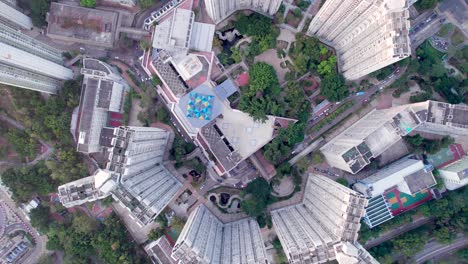 five identical high-rise apartment buildings with artificial gardens in the middle of the densely populated ma on shan in hong kong