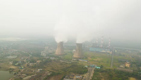 aerial view of smoke-emitting factories in india, reflecting industrial growth and environmental impact.