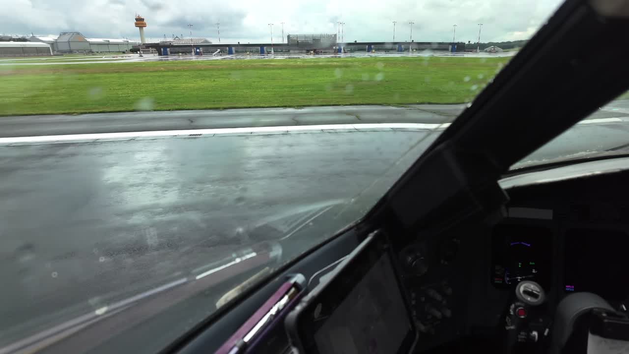 An immersive pilot FPV from cockpit aligning the jet airplane into the wet runway ready for takeoff in a rainy day
