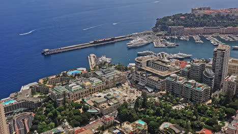 monaco aerial v24 birds eye view tilt up shot from famous casinos reveals downtown cityscape capturing yachts docked at port hercule and beautiful blue mediterranean sea - july 2021